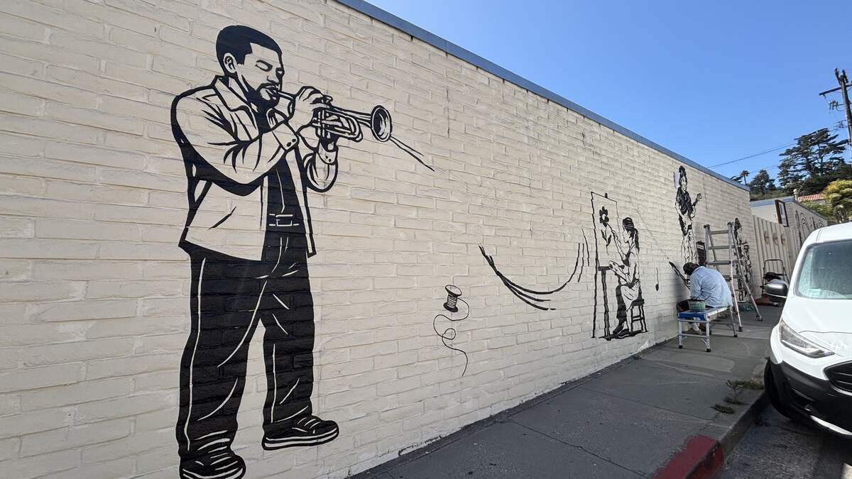 A black-and-white mural on the side of Village Creative showcases artists and musicians, seen here on July 28, 2026. A black-and-white mural on the side of Village Creative showcases artists and musicians, seen here on July 28, 2026.